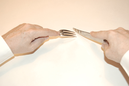 holding a fork when also using a knife